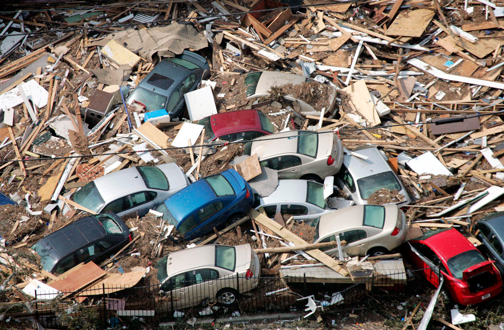 Cars lie piled up among other debris from Hurricane Katrina in Gulfport, Mississippi on Wednesday, Aug. 31, 2005. (AP Photo/David J. Phillip)